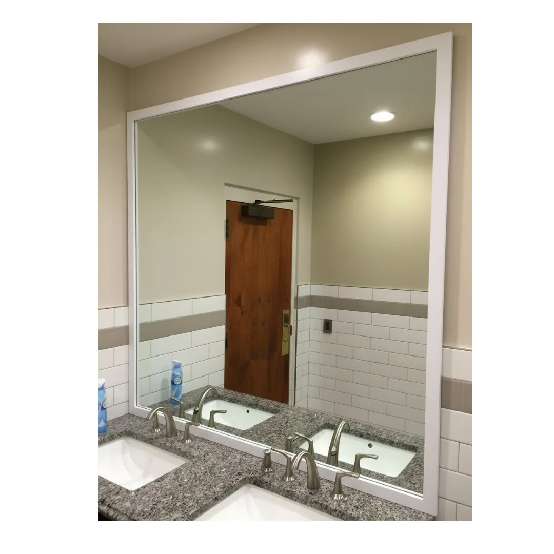 Modern bathroom vanity with white framed mirror and dual sinks